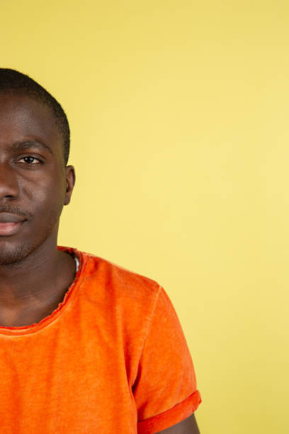 istock African young male portrait isolated on yellow studio background with copyspace for ad. 1321722406