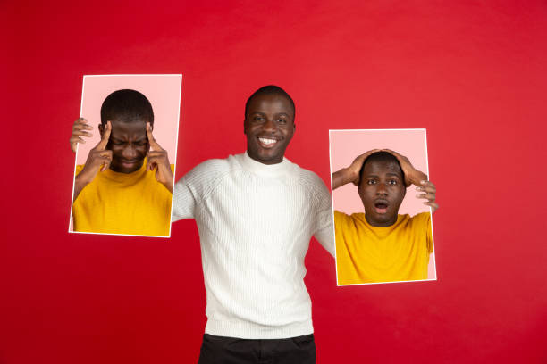 istock Young african man holding his portraits isolated over red studio background with copyspace for ad. 1321722445