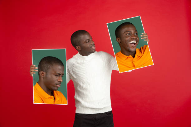 istock Young african man holding his portraits isolated over red studio background with copyspace for ad. 1321722450