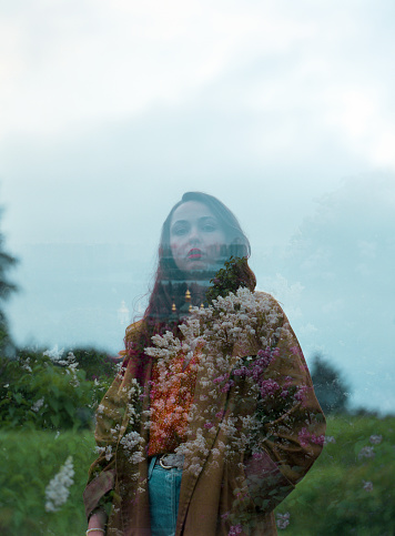 Portrait of young Caucasian woman on the background of blooming lilac, Camera film, double exposure