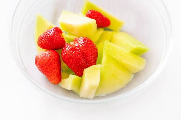 Fancy cut melon with assorted fruit inside.