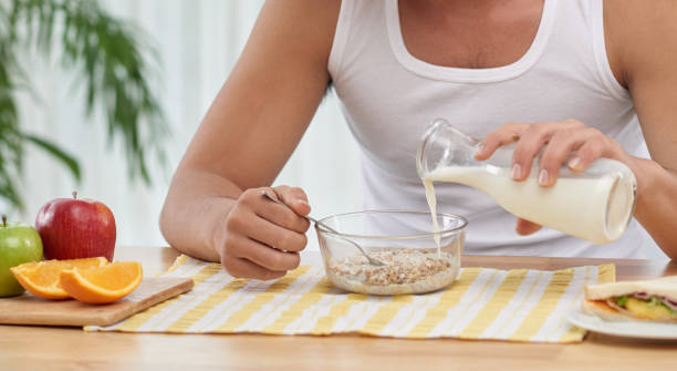 istock Asian man pouring milk 1321727851