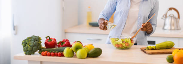 istock African Lady Cooking Vegetable Salad Standing In Modern Kitchen Indoors 1321728093