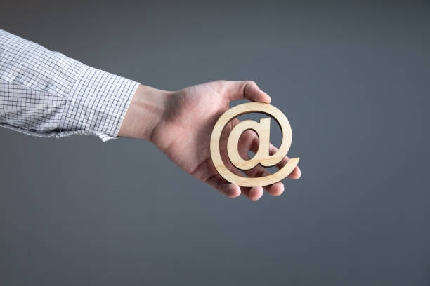 istock man holding wooden email sign 1321728493