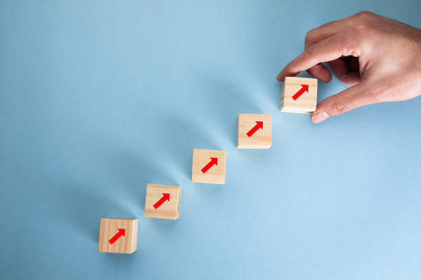 istock Wooden cubes to the top with arrows. 1321728524