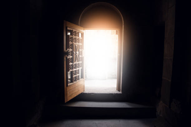 istock open dark church door and light 1321728544
