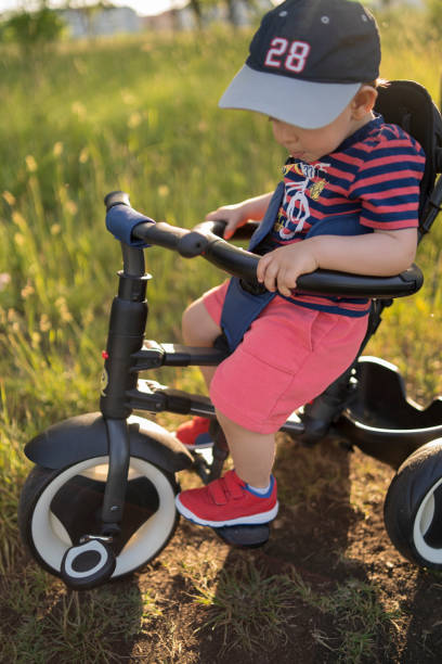 istock Cute toddler boy, playing with tricycle 1321730825