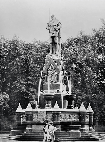 Roland is an ancient symbol of urban jurisdiction.The Roland fountain was a monumental fountain on Kemperplatz in Berlin-Tiergarten. The gift of Kaiser Wilhelm II to his royal seat, inaugurated in 1902, formed the southern end of Siegesallee in the Großer Tiergarten. The remains of the well, which was badly damaged in World War II, were cleared around 1950. Image from 19th century