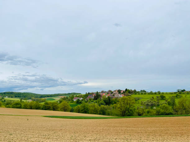 istock Agricultural field and small village 1321731238