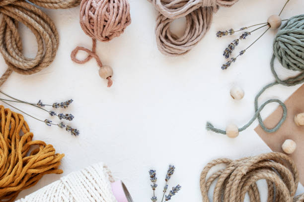Beautiful layout of materials for macrame: cotton cords, jute twine, wooden beads. Flat lay. Beautiful layout of materials for macrame: cotton cords, jute twine, wooden beads. Flat lay. Hobby concept, copy space. macrame stock pictures, royalty-free photos & images