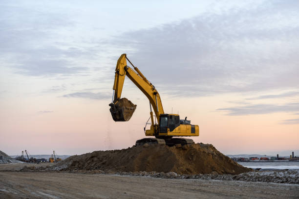 istock Yellow excavator working on construction site. The road construction. 1321732395