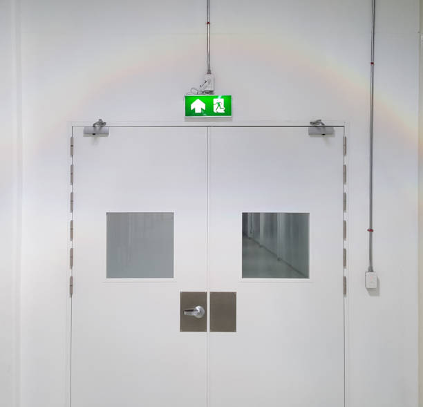 istock Emergency exit door way with green exit light sign, clean area, walk path way in the GMP factory 1321732584