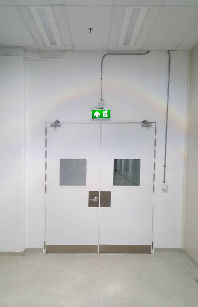 istock Emergency exit door way with green exit light sign, clean area, walk path way in the GMP factory 1321732601