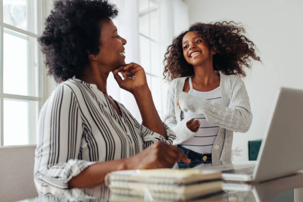 istock Girl playing with mother working from home 1321733200