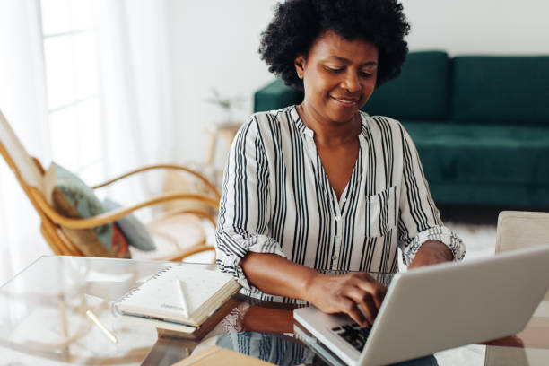 istock Woman using laptop at home 1321733208
