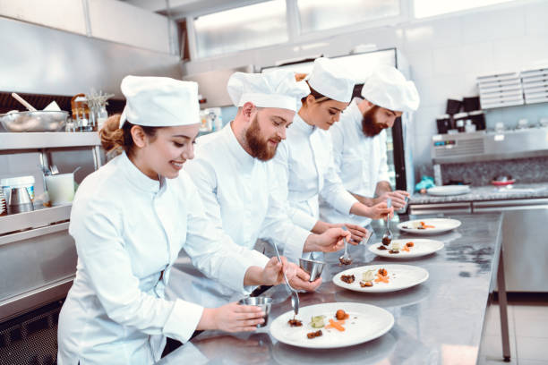 istock Many Cooks Doing Food Topping Time Trial Competition In Kitchen 1321735109