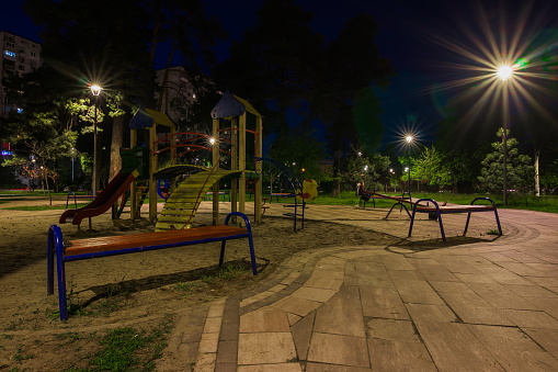 Children playground at night in the green city park