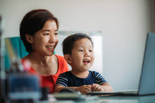 istock Asian chinese mother with son working and using laptop in office 1321738139