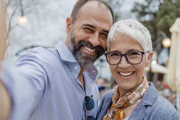 istock Cheerful mature couple is taking selfie. POV 1321743649