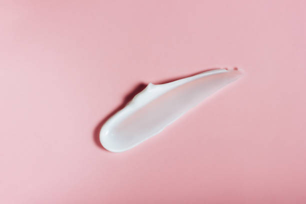 White skin cream smear on pink background White skin cream smear on pink background White Discharge  stock pictures, royalty-free photos & images