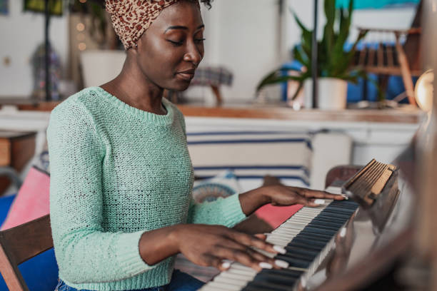 istock Woman playing a piano 1321749892