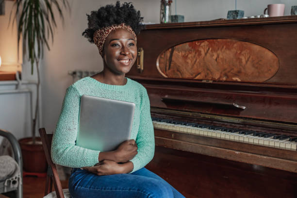 istock Piano teacher holding laptop 1321750027