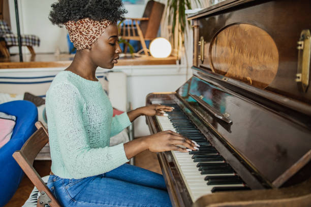 istock Woman playing a piano 1321750035