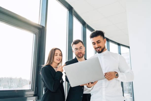 istock Two office workers show their new project to the boss 1321752671