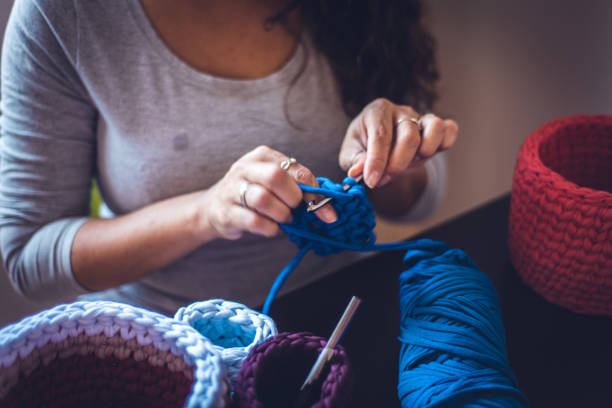 istock Close-up of female entrepreneur producing crochet art. 1321754340