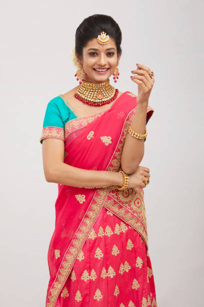 istock Beautiful smiling Indian bride with jewelry in studio shot. 1321754835