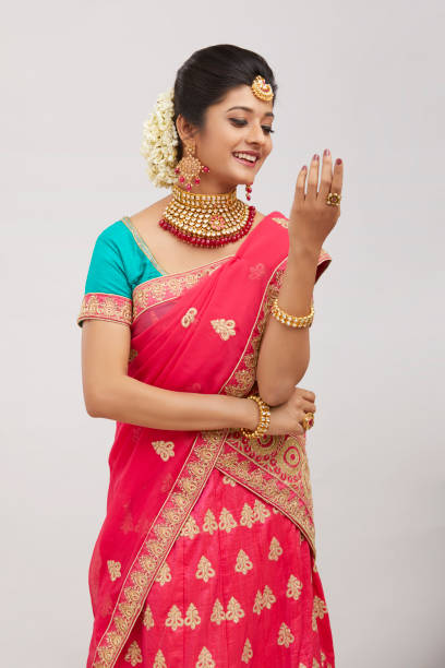 istock Beautiful smiling Indian bride with jewelry in studio shot. 1321754836