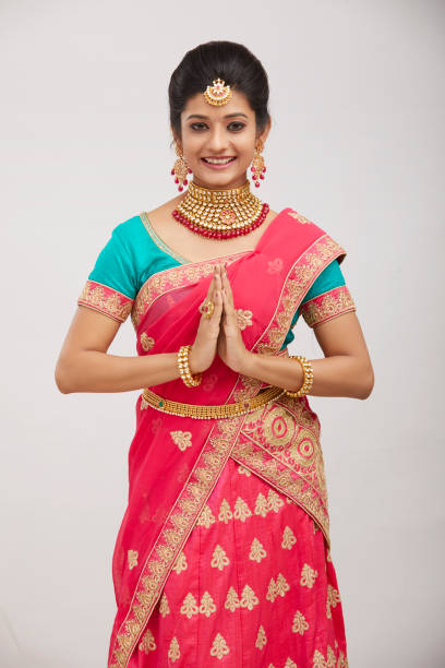 istock Beautiful smiling Indian bride greeting with jewelry 1321754871