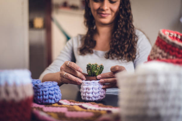 Woman producing crochet art