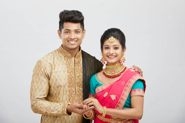 Attractive happy north Indian couple in traditional dress Attractive happy north Indian couple in traditional dress on white/ south indian lady stock pictures, royalty-free photos & images