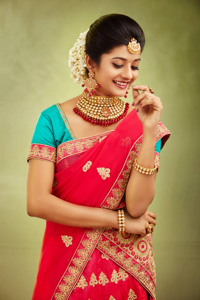 istock Beautiful smiling Indian bride with jewelry in studio shot. 1321755176