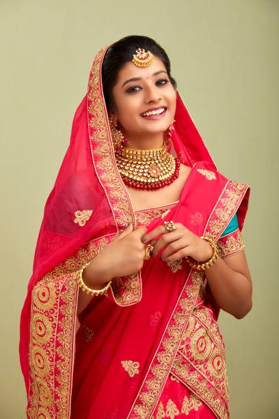 istock Beautiful smiling Indian bride with jewelry in studio shot. 1321755177