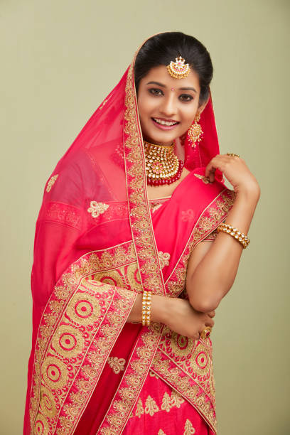 istock Beautiful smiling Indian bride with jewelry in studio shot. 1321755210