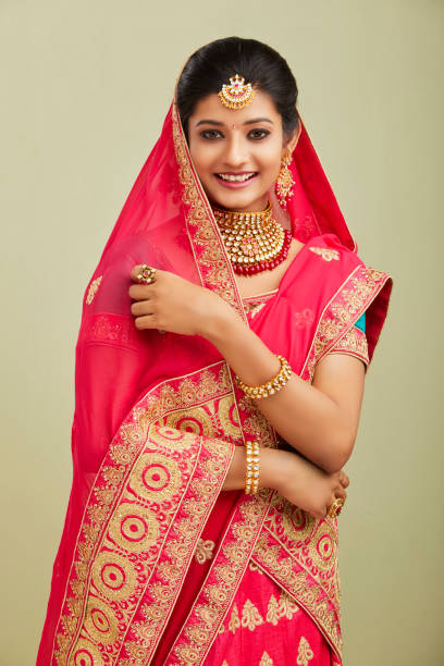 istock Beautiful smiling Indian bride with jewelry in studio shot. 1321755211