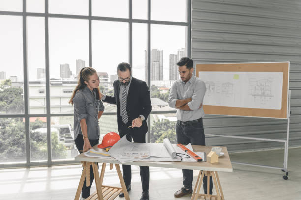 istock Engineers team meeting for architectural project. architects discussing blueprint with construction manager in office worker conference site. Construction Concept 1321762753