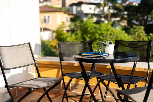 istock balcony with table and chairs in a sunny day. New normal 1321763818