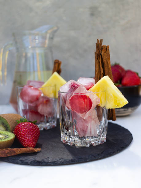istock Drink with strawberry ice and pineapple slices on a gray background 1321764160