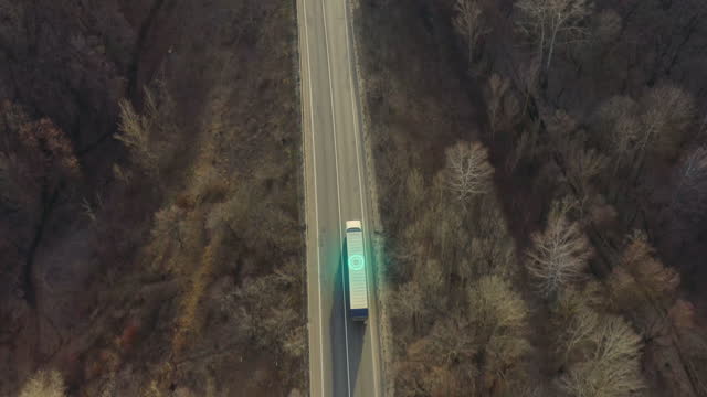 Logistics concept: transportation and delivery of goods on a truck with a semi-trailer - aerial shot