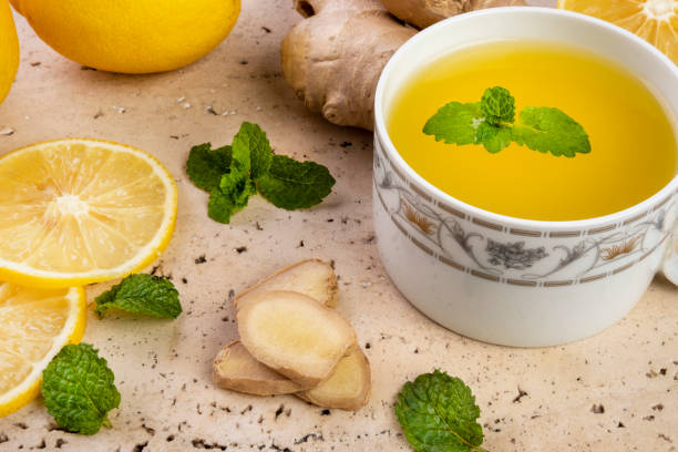 istock Sicilian lemon tea, ginger and mint leaves on white marble stone 1321766845