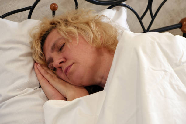 istock The woman lies on a pillow with her hands folded under her head. 1321767120