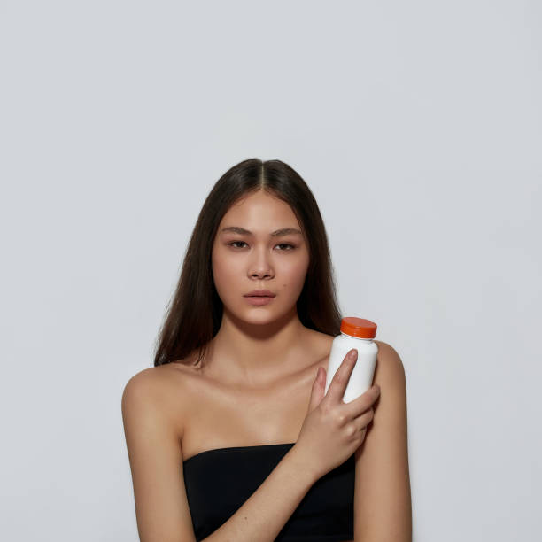 istock Young asian girl holding wellness vitamins 1321767191