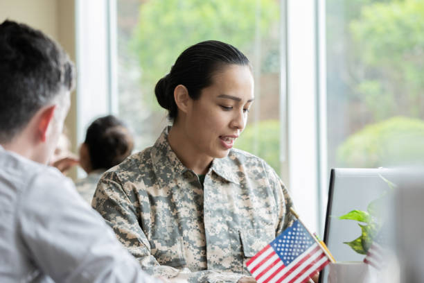 istock Female military recruiter explaining options to servicemen. 1321768134