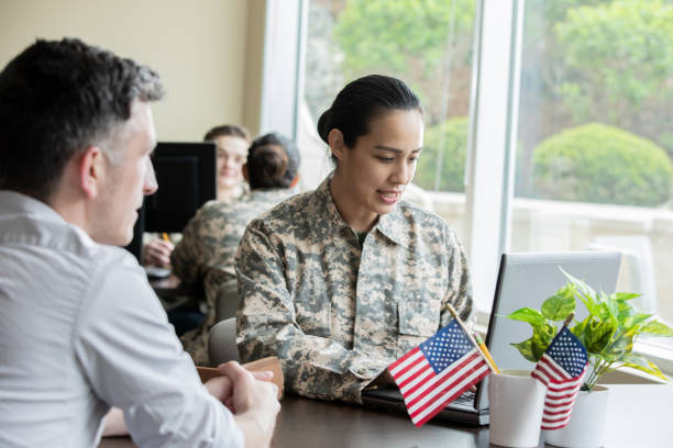 istock Female military recruiter listening while discussing options with another soldier 1321768138