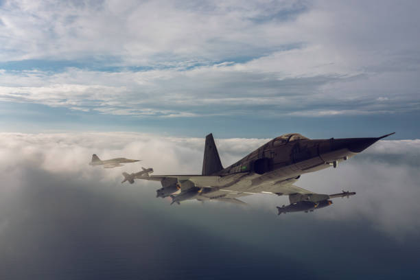 istock Jet fighters flying over the clouds. 1321770723