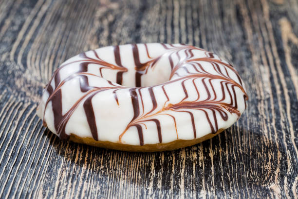 istock a fresh doughnut covered with white chocolate , closeup 1321772830