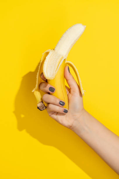 istock Hand holding peeled banana 1321774832